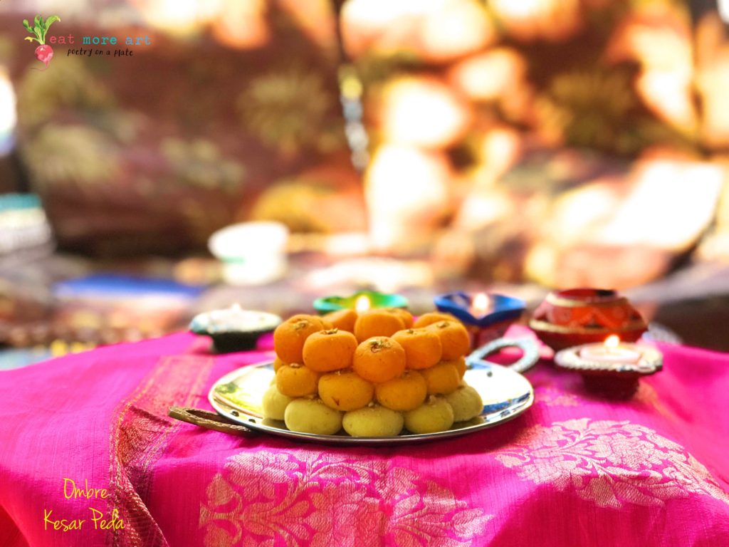 Ombre saffron peda in shades of yellow and orange stacked on a plate on hot pink background