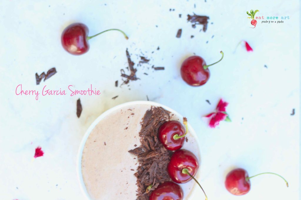 An overhead shot of cherry garcia smoothie bowl garnished with dark chocolate and cherries