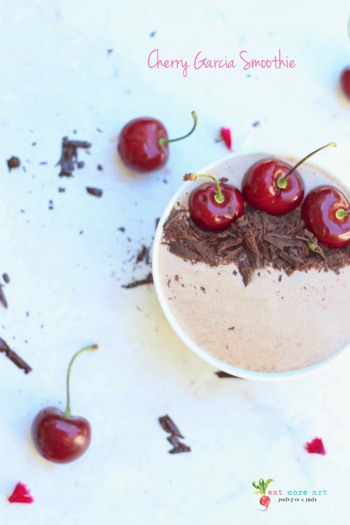 An overhead shot of cherry garcia smoothie bowl garnished with dark chocolate and cherries
