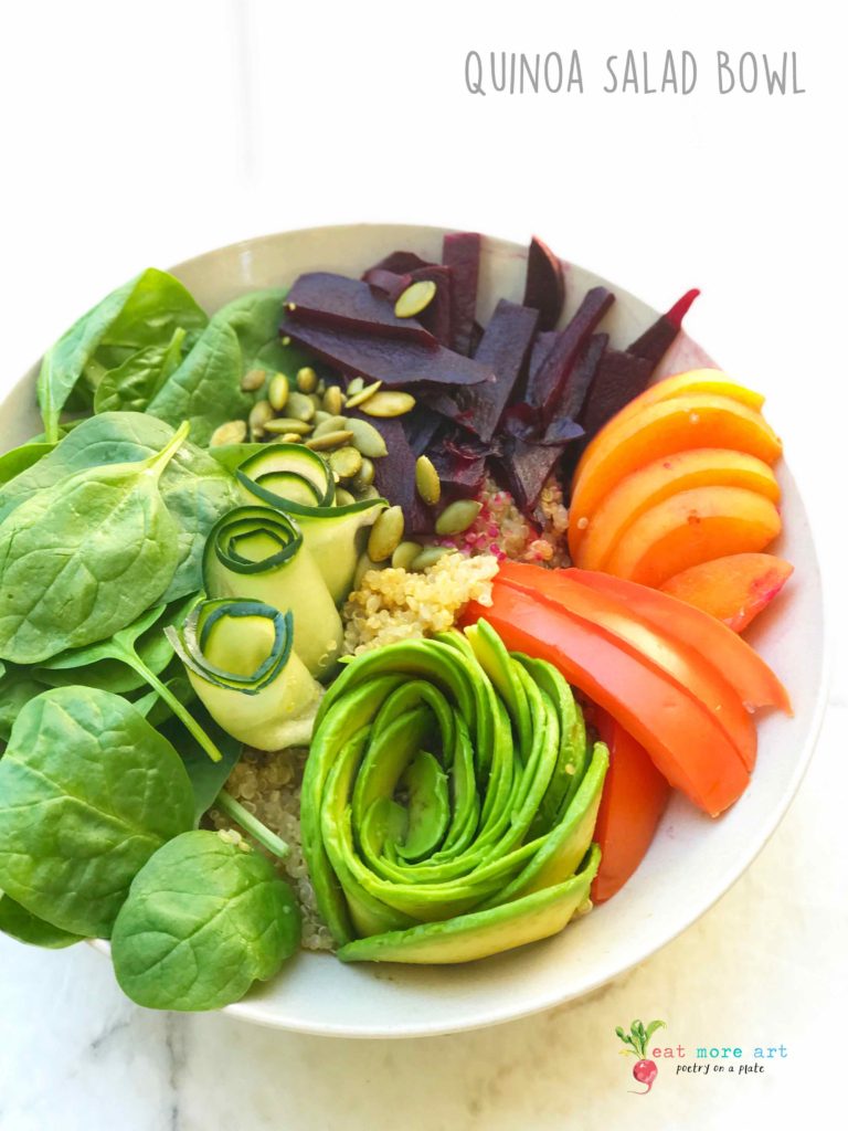 An overhead shot of vegan quinoa salad bowl with fruits and veggies
