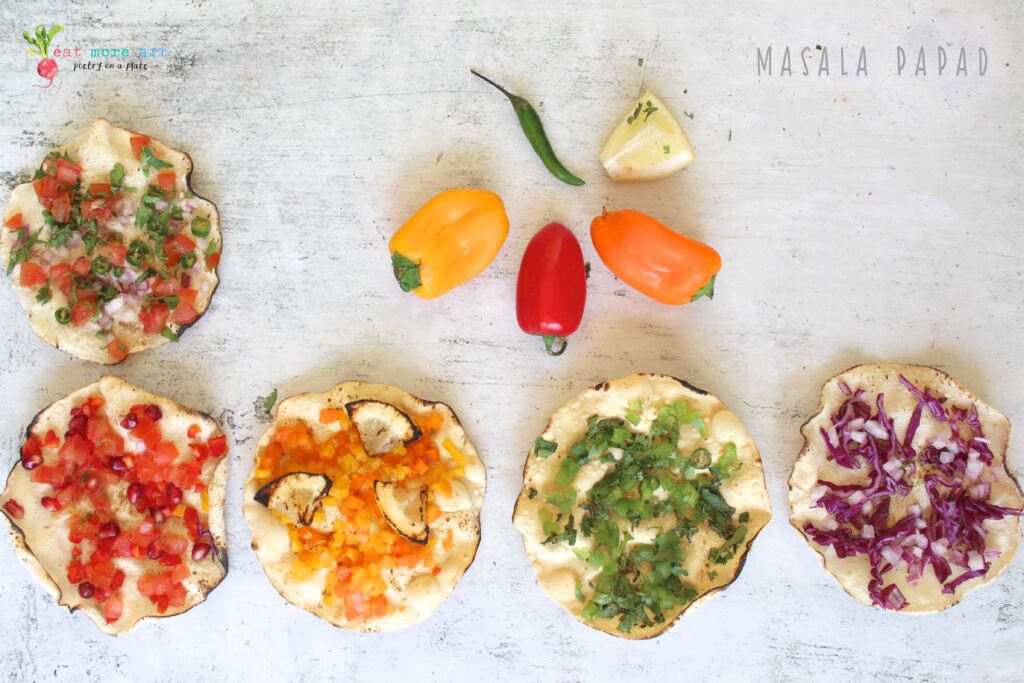 an overhead shot of masala papads topped with colorful vegetables