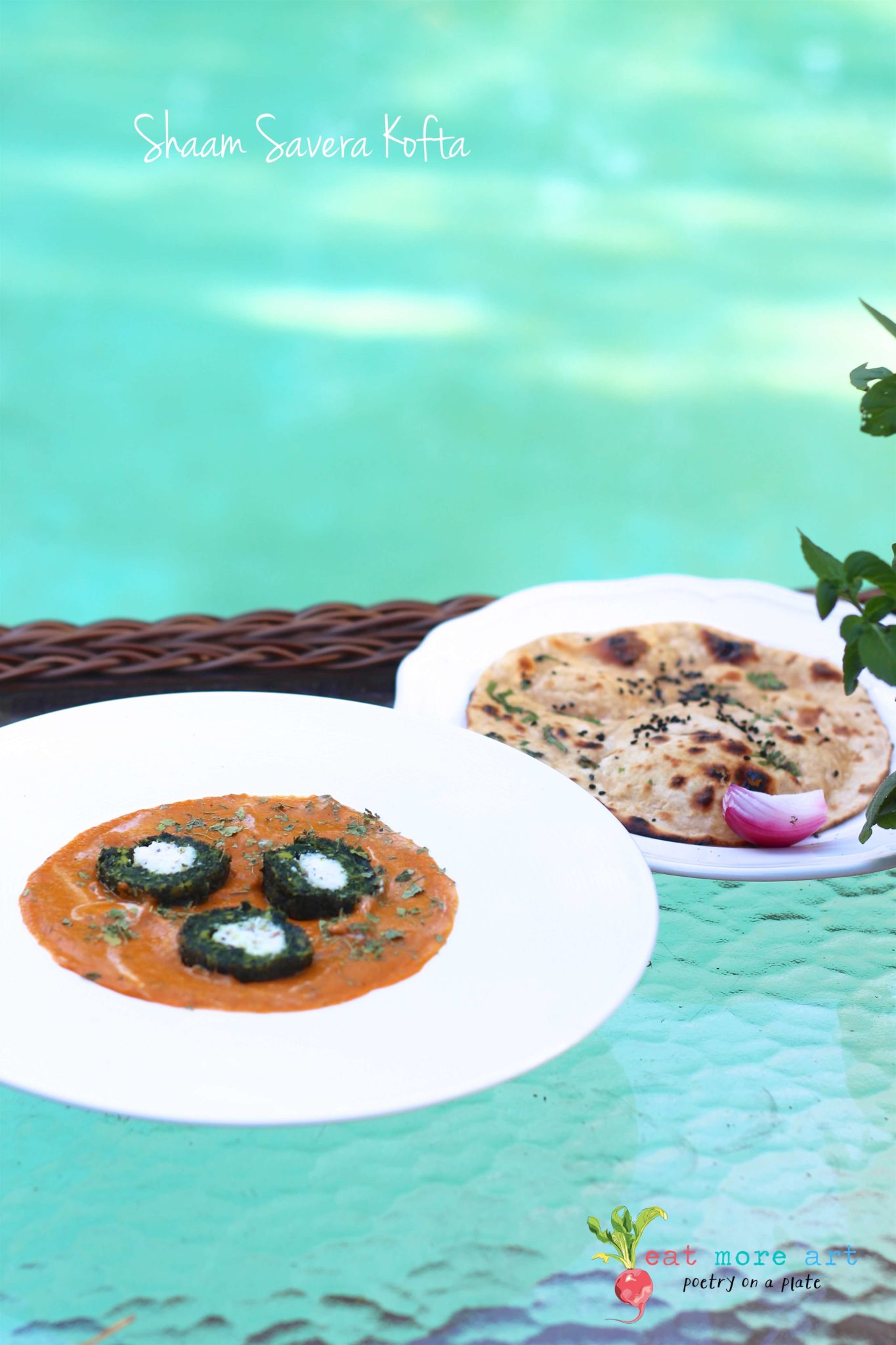 A plate of green spinach kofta with cut in half with white panner in center served with a side of roti with teal color pool background