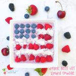 An overhead shot of square smoothie bowl with berries arranged like american flag