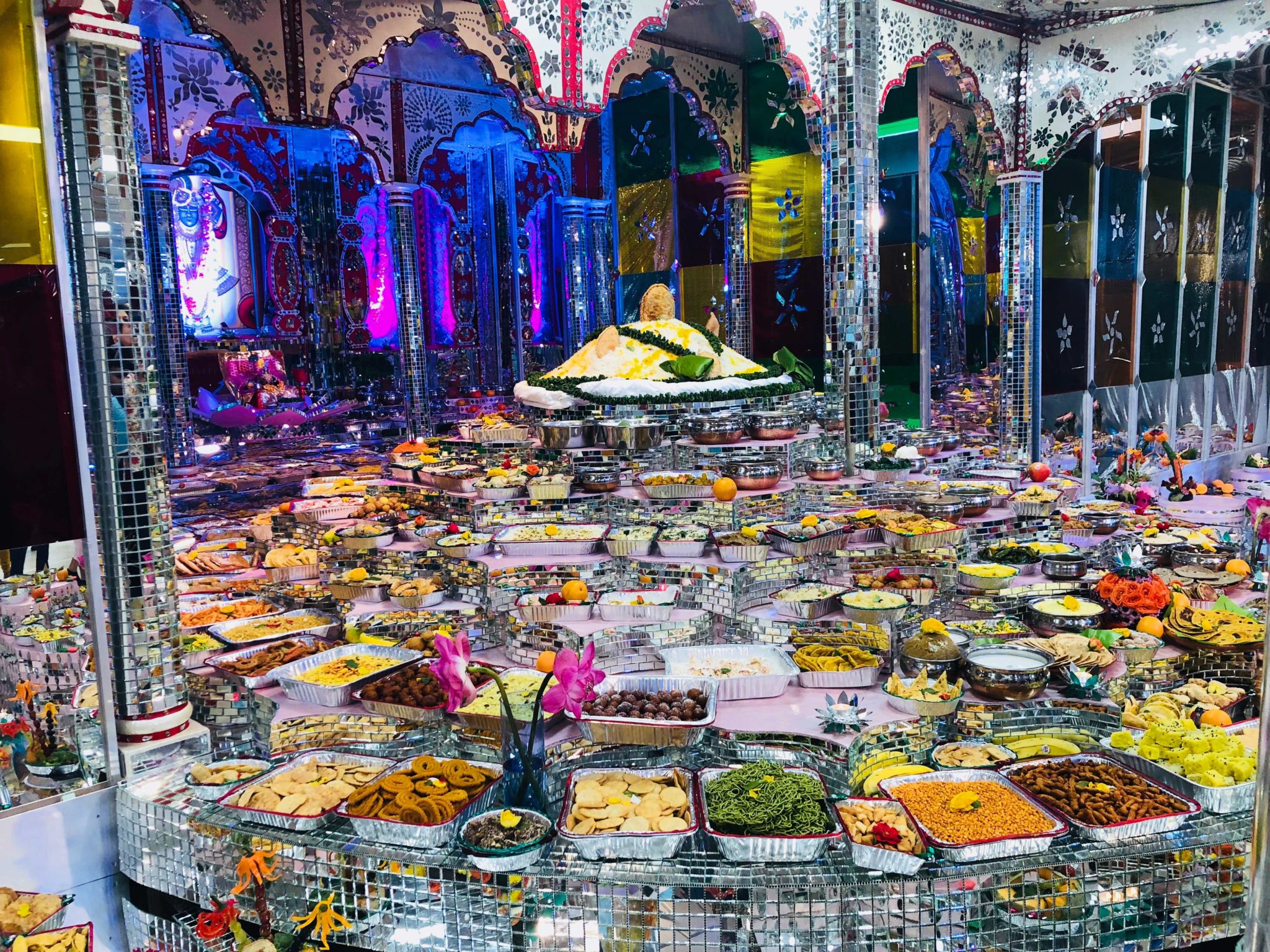 a picture of annakut celebrations with 100s of food items offered in front of God