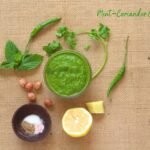 an overhead shot of mint-cilantro chutney with ingredients placed on the side