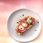 An overhead shot of Beetroot Hummus Toast topped with radishes